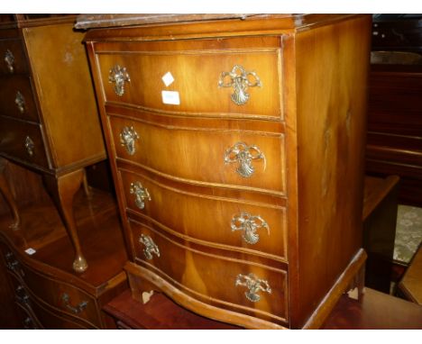 Small reproduction yew wood serpentine fronted chest of four drawers on bracket feet, together with a three drawer walnut bed