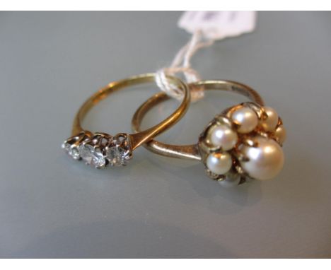 Yellow gold three stone diamond set ring, together with a yellow gold pearl set flower head ring