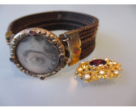Early 19th Century garnet and pearl brooch, together with a 19th Century hair work bracelet, the clasp inset with a painted m