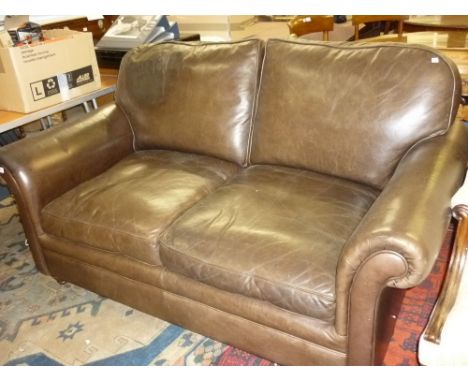 Laura Ashley brown leather upholstered two seat sofa with loose back and seat cushions on turned front supports