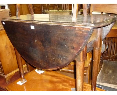 Antique oak oval gate leg table on tapering supports with pad feet