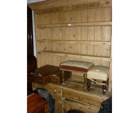 19th Century stripped pine Welsh dresser with a boarded shelf back above two drawers and two panelled doors and shaped feet