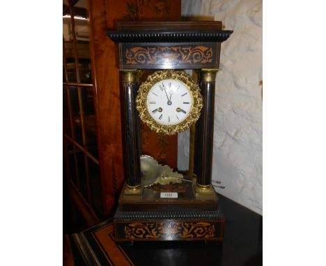 19th Century French ebonised marquetry inlaid gilt metal mounted portico clock, the enamel dial with Roman numerals and two t