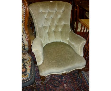 19th Century walnut button upholstered armchair raised on carved cabriole front supports with casters