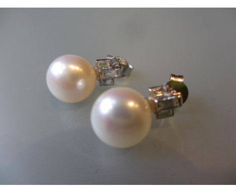 Pair of 18ct White gold cultured pearl and baguette cut diamond stud earrings