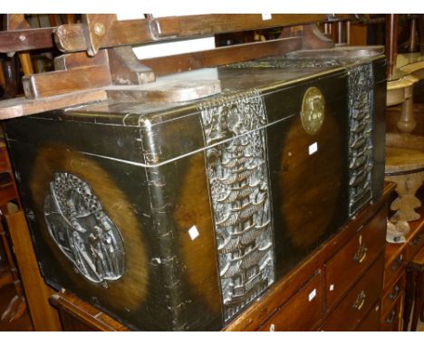 Mid 20th Century oriental carved and stained camphor wood trunk decorated in high relief with bands of figures on horseback a