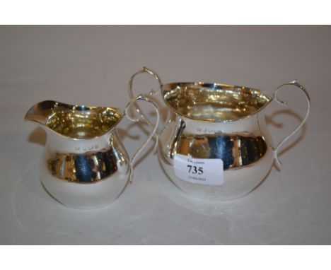 Birmingham silver helmet shaped cream jug and matching sugar basin