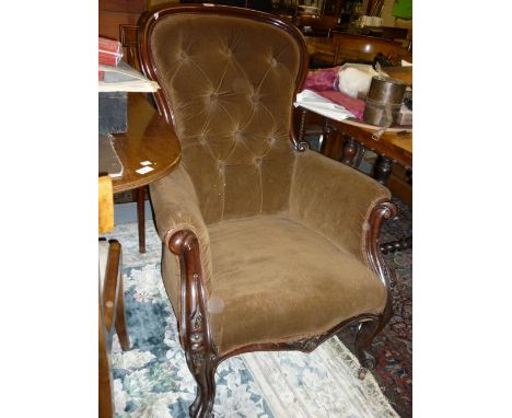 Victorian carved mahogany and button upholstered drawing room armchair on floral carved cabriole front supports