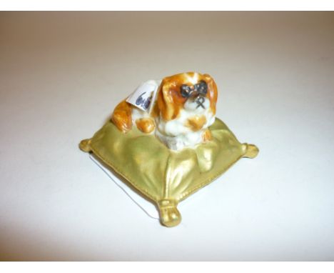 Small Royal Worcester figure of a King Charles spaniel seated on a cushion