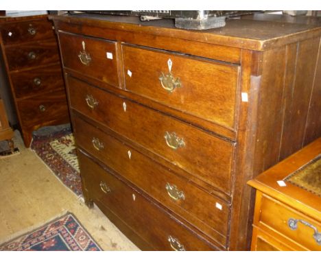 Early 19th Century oak chest of two short and three long drawers with brass handles and ivory escutcheons flanked by canted c