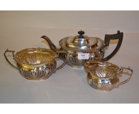 Silver three piece tea service of shaped rectangular form with shell and gadroon rims, London 1904