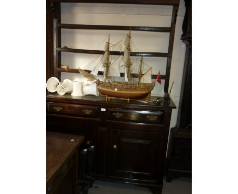 Mid 18th Century oak dresser with open rack having three shelves over two short drawers with brass swan neck handles and a fu