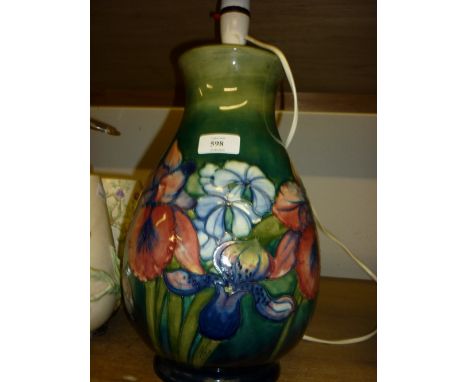 Large Moorcroft floral and tube line decorated baluster form table lamp base on a blue green ground, 14ins high
