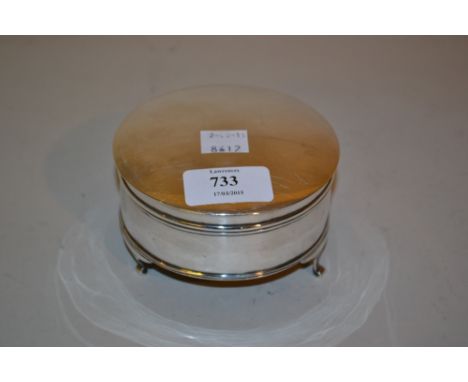 Circular silver trinket box with hinged cover and low supports