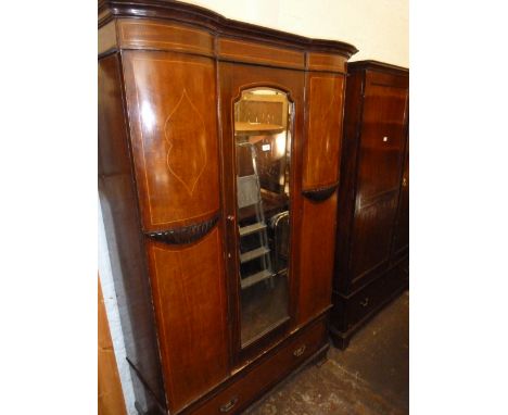 Edwardian mahogany line inlaid single door wardrobe having moulded cornice above a central bevelled edge mirrored door, flank