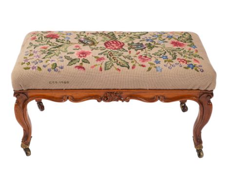 A Victorian carved walnut and pine long stool in 18th century taste; 19th century and adapted; with later floral tapestrywork