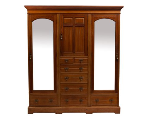 An Edwardian mahogany compactum wardrobe, early 20th century; with moulded cornice above a central panel door and a file of t