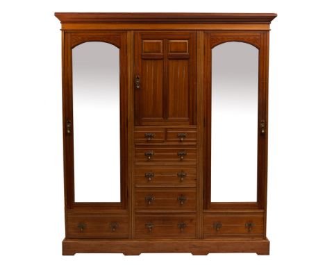 An Edwardian mahogany compactum wardrobe, early 20th century; with moulded cornice above a central panel door and a file of t