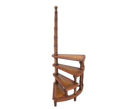 A flight of mahogany library steps in Regency style, later 20th century; the four treads with gilt tooled leather treads spir