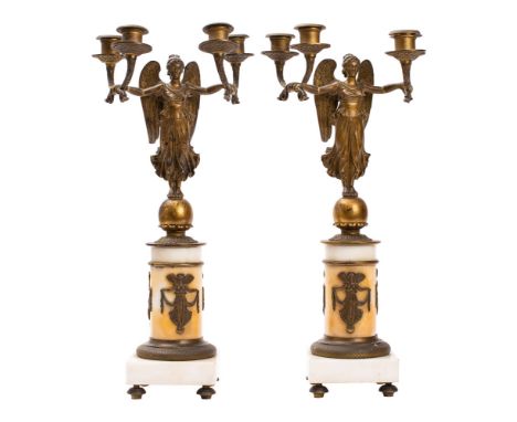 A pair of gilt bronze and white marble mounted four light figural candelabra in Empire style, late 19th century; in each case