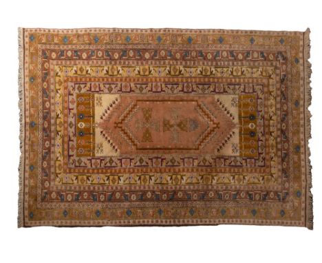 A Genge carpet, the beige filed with a hexagonal stepped panel with cruciform designs, enclosed by a multiple border with sty