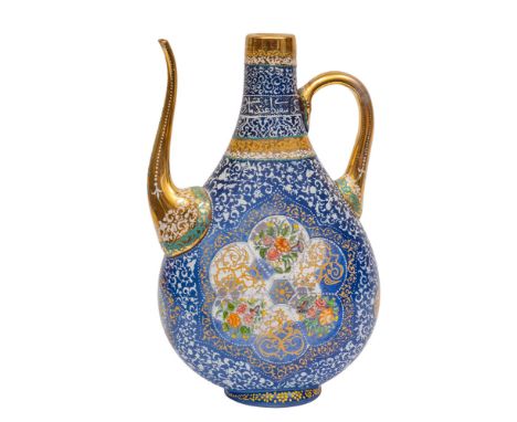 An enamelled blue glass ewer of flattened tear drop form enamelled front and verso with alternating panels of scroll work and