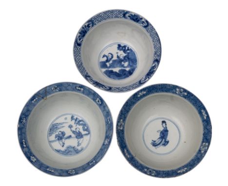 A group of three Chinese blue and white 'Klapmuts' bowls, Kangxi the first painted with elegant ladies and children playing i