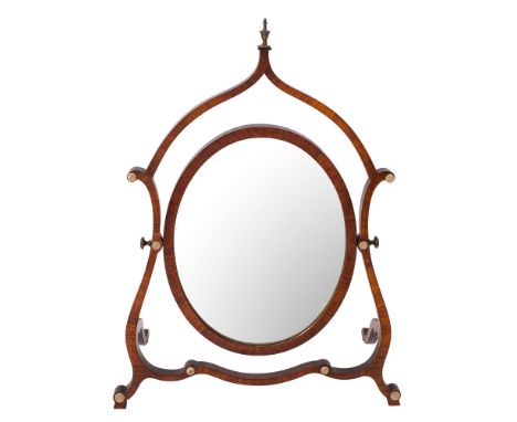 An Edwardian mahogany skeleton swing frame toilet mirror in the George III manner, inset with an oval plate, the surround wit