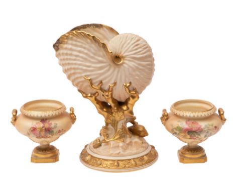 A Royal Worcester porcelain Nautilus vase under ivory and gilt decoration, together with a pair of two handled squat pedestal