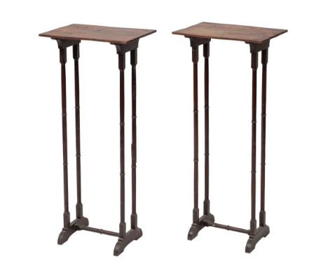 A pair of Regency mahogany vase or lamp stands, early 19th century; the rectangular tops on straight, knopped, slender legs t