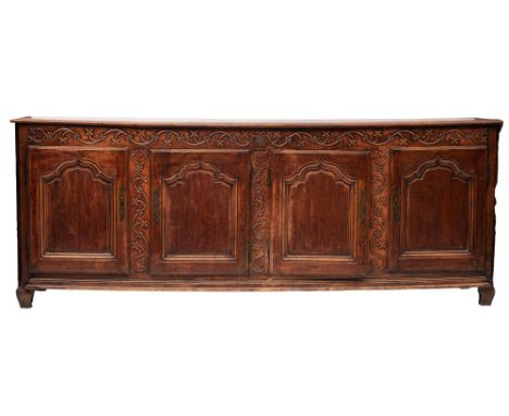 A Louis XV oak and walnut side cabinet or dresser, third quarter 18th century; the top with moulded front and side edges; abo