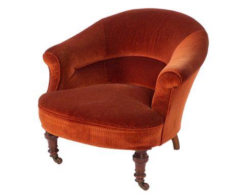 A Victorian brick red corduroy upholstered tub armchair, late 19th century; with outscrolled arms; the knop turned front legs