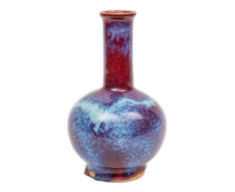 A Chinese flambe bottle vase with globular body and cylindrical neck, covered in a rich ox-blood, purple and white glaze, apo