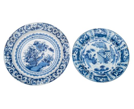 A Dutch blue and white delftware dish in Kraak style and one similar the first painted with Chinese figures on a terrace with