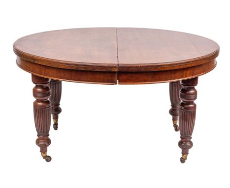 A Victorian mahogany extending dining table, last quarter 19th century,: the oval top with moulded edges, above plain friezes