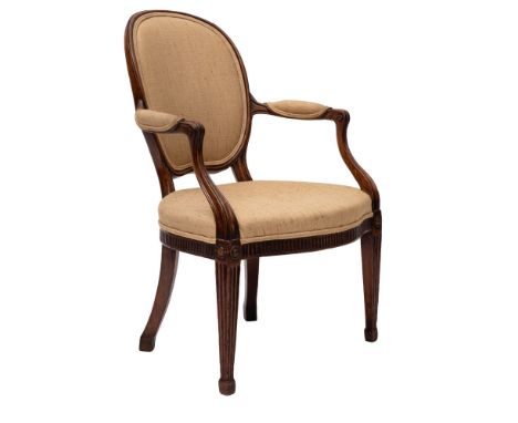 A George III mahogany open armchair in the manner of John Linnell with oval upholstered panel back, padded arm supports and s