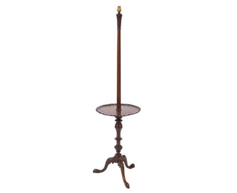 A mahogany standard lamp in George III taste, early 20th century; the electrical fitment atop a shaft rising from a tripod oc