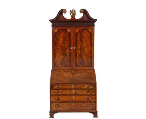 A George III mahogany and inlaid bureau cabinet, last quarter 18th century; with repousse gilt metal eagle finial within a 'b