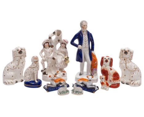 A mixed group of Staffordshire figures comprising a portrait figure of the Duke of Wellington,  a pastoral taper vase group, 