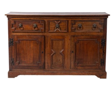 An oak dresser base in William and Mary style, circa 1900; the top with moulded front and side edges; above a short drawer fl