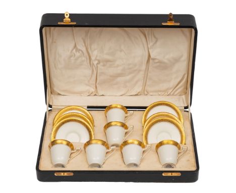 A Royal Worcester porcelain coffee set comprising six cups and six saucers each with tooled gilt trim, blue backstamps and da