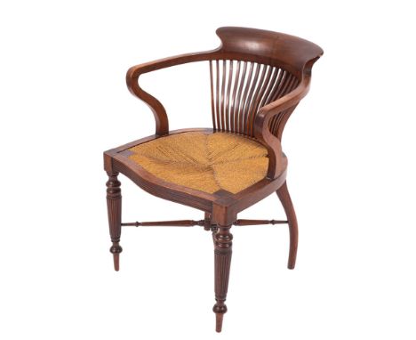 An Edwardian mahogany office desk armchair in the manner of Shoolbred, of tub-shaped outline, the back with curved top rail a