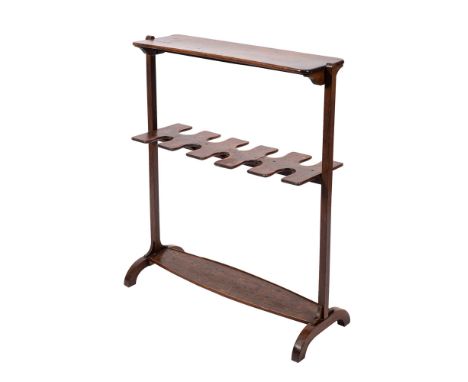 A 19th Century mahogany boot rack surmounted by a rectangular shelf, having ten central divisions on twin square section upri