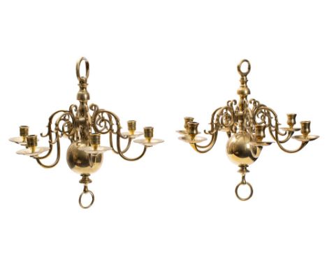 Two similar brass six light chandeliers, late 18th /early 19th century; the urn sockets and dished circular drip pans on scro