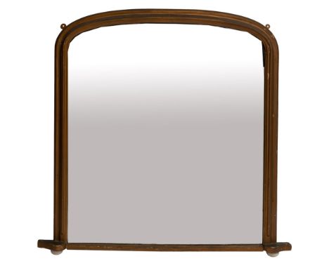 A Victorian giltwood framed overmantel mirror, late 19th century; of shallow arched rectangular form, the base with twin whit