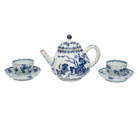 A small Chinese blue and white ribbed teapot and cover and a pair of similar teabowls and saucers, Kangxi painted with flower