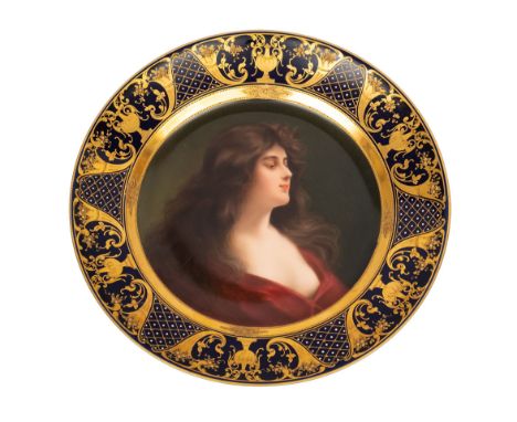 A Volkstedt porcelain cabinet plate painted in the Vienna manner with the portrait of a semi-nude maiden, the midnight blue r