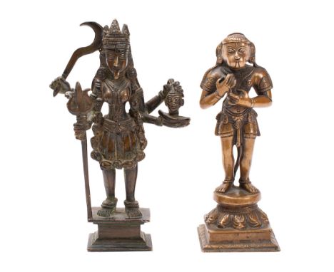An Indian bronze figure of Kaali and a similar figure of Hanuman the Hindu goddess holding a sickle, a trident and a severed 