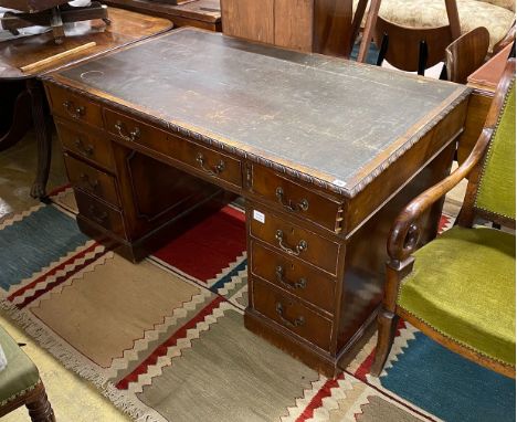An early 20th century Chippendale revival mahogany pedestal desk, requiring restoration, length 135cm, depth 79cm, height 73c