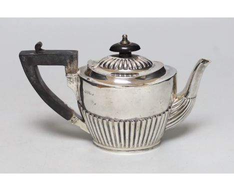 A late Victorian demi-fluted silver bachelor's teapot, London, 1885, gross weight 8.3oz.